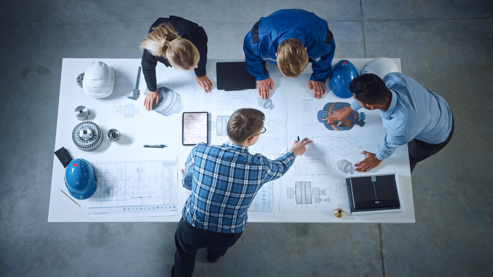 blueprints on a table with hands pointing to the blueprints in Portland, Oregon